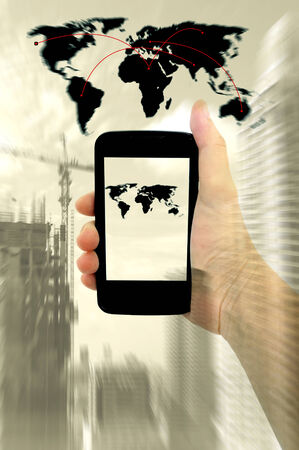 Double expose of human hands with digital phone and cityの写真素材