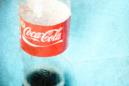 BANGKOK - March 4: Coca Cola bottle on abstract blend on grunge wall on Mar 4, 2015 in Bangkok,...