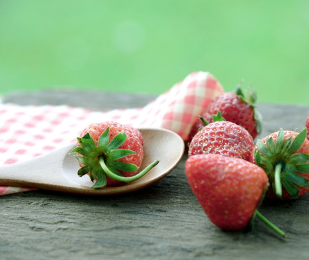 Strawberries in wooden spoonの写真素材