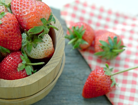 Fresh strawberry in wooden bucketの写真素材