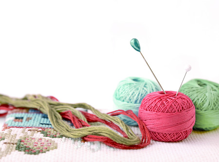 Few pins in wool ball isolated on whiteの写真素材