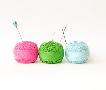 Few pins in wool ball isolated on whiteの写真素材