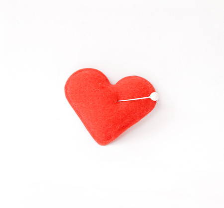 Red heart, studded with a pinの写真素材