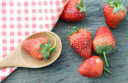 Strawberries in wooden spoonの写真素材