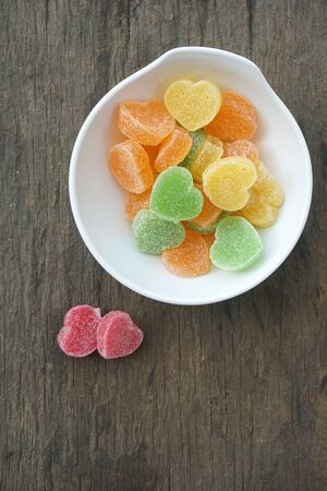 Fruit jelly hearts on wooden tableの写真素材