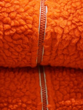 zipper on orange wool texture backgroundの写真素材
