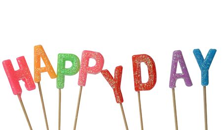 Colorful candles in letters saying Happy day, isolated on white backgroundの写真素材