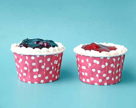 Two cupcake ornaments on blue backgroundの写真素材