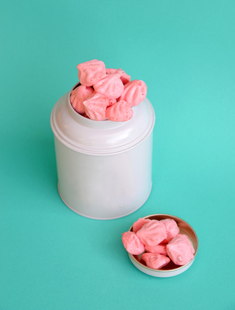 pink meringue cookies in white bottleの写真素材
