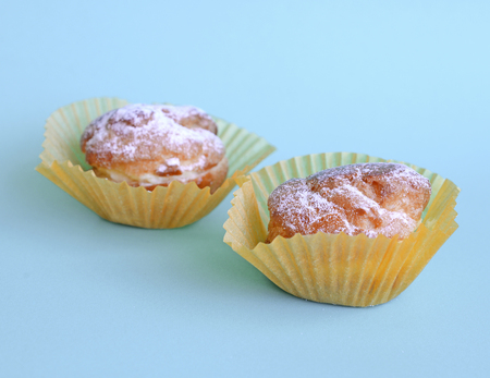Profiterole or cream puff with filling and powdered sugar toppingの写真素材