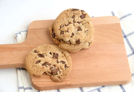 close up of home made chocolate chip cookies on a wooden plateの写真素材