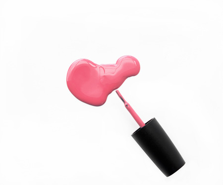 Pink nail polish and brush on white backgroundの写真素材