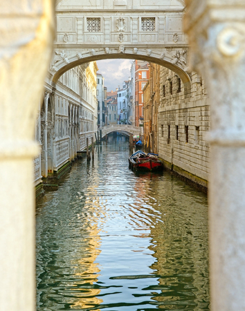 Gondola on small canal passing towards famous Bridge of Sighs (Ponte dei Sospiri) in Venice, Italy.の写真素材