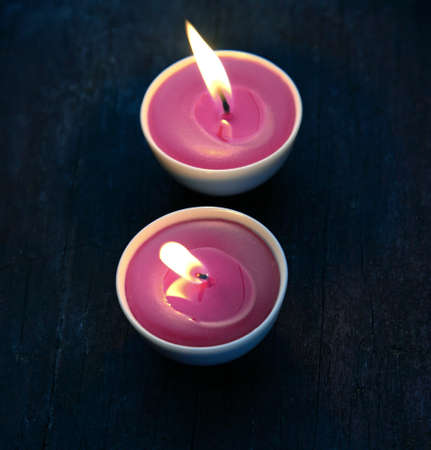 Burning candles in white small glassの写真素材
