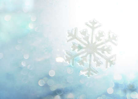 Abstract winter blue bokeh snowflake backgroundの写真素材