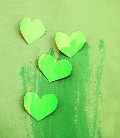 paper green heart with green colorwater paint background (go green concept)の写真素材