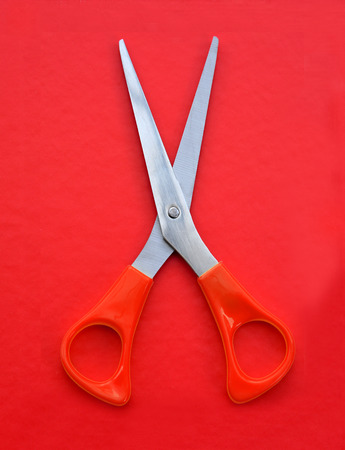 red scissors on red backgroundの写真素材