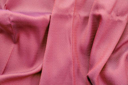 Pink silk fabric background with textureの写真素材