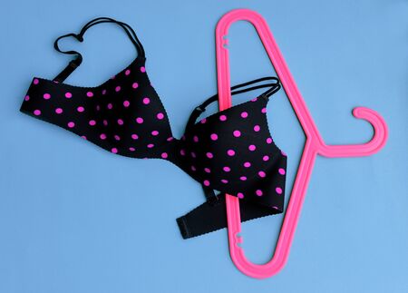 Summer concept, bra on coat hanger on blue. (Pop art style)の写真素材