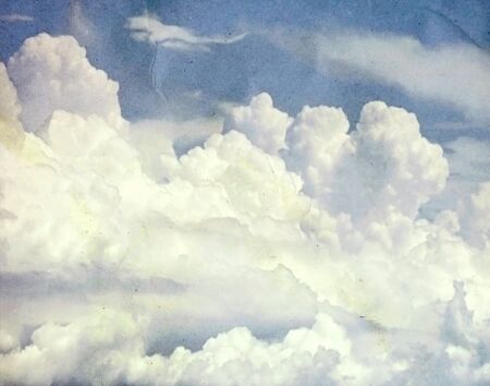 Blue sky with some white puffy clouds, Vintage tone.