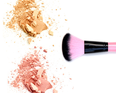 close up of a make up powder and brush on white background