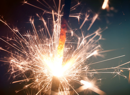 sparkler on gold bokeh background macro close upの写真素材