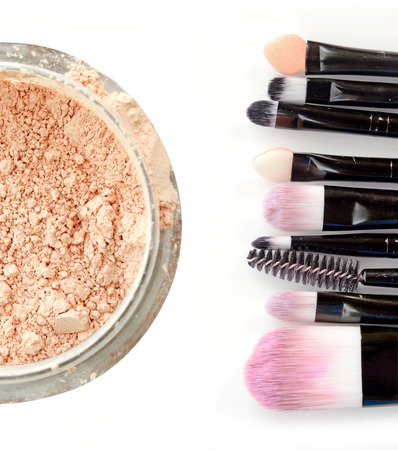 Face powder and various brushes close up isolate on white.の写真素材