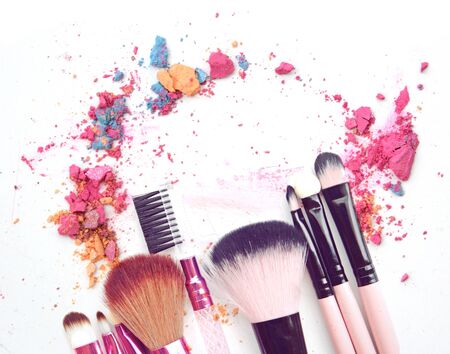 Cosmetic powder brush crushed and lipstick smear isolated on whiteの写真素材