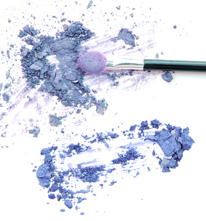 Mixed crushed make up eyeshadow with brush. Isolate on white.の写真素材