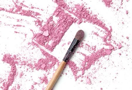 Close up of crushed blush on white background and cosmetic brushの写真素材