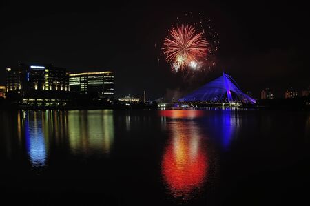 Colorful fireworks reflection with beautiful bridge sceneryの写真素材