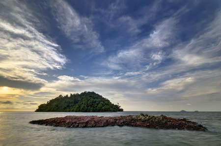 Rocks on the beach during sunsetの写真素材