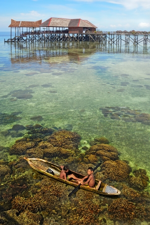 MABUL ISLAND 13 April 2013   Unidentified Sea Bajau s children rowing on a boat のeditorial素材