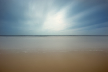 Beach and blue moving skyの写真素材