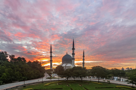 Moving red clouds over the mosqueの写真素材