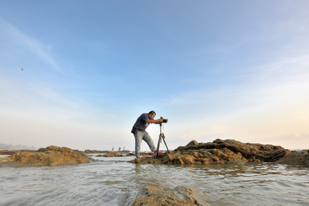 The Photographer takes a good shot at the beachのeditorial素材