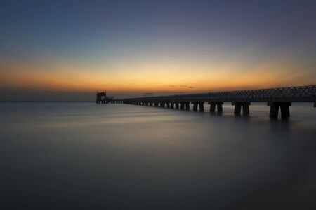 Beautiful sunrise with concrete building at the beachの写真素材