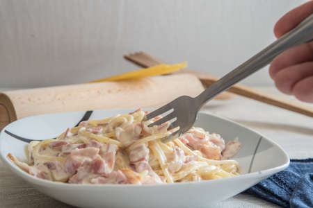 spaghetti to bacon and egg for dinner on porcelain plateの写真素材