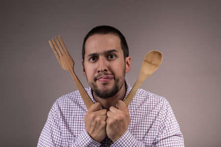 boy with wooden cutlery eager to eat