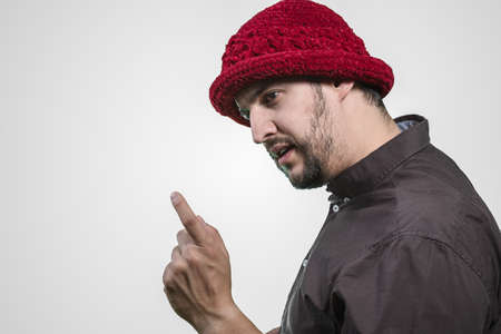 young man with threatening attitude and hatの写真素材
