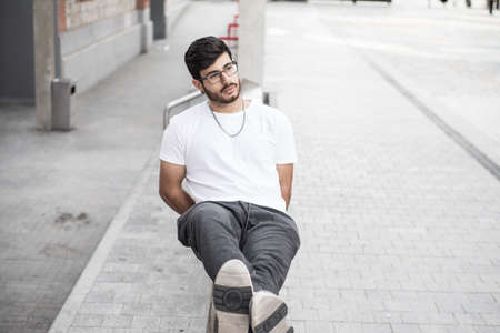 man with a beard leaning on a handrailの写真素材