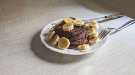 dietetic pancakes with banana on an old countertopの写真素材