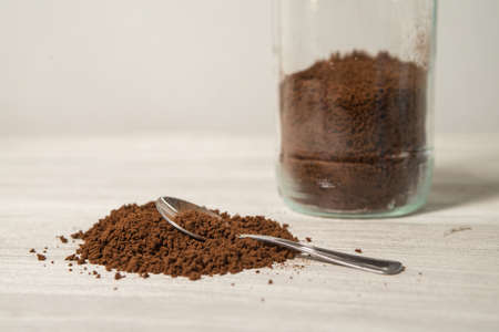 Instant coffee granules scattered brown close up.の写真素材