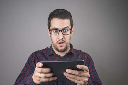 Portrait of surprised man talking on smartphone