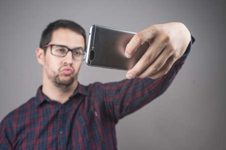 Portrait of man playing with smart phone or tablet