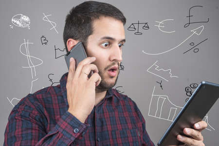 businessman with smart phone and tablet, solving his finances