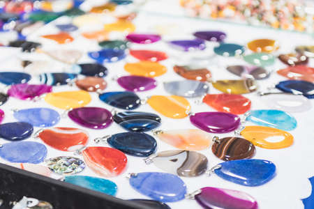 polished stone pendants placed for sale in a street stall