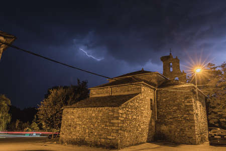 Stone church, a sky with clouds and lightningのeditorial素材
