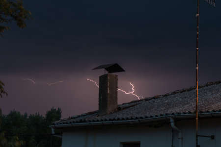 village chimney, a sky with clouds and lightningのeditorial素材