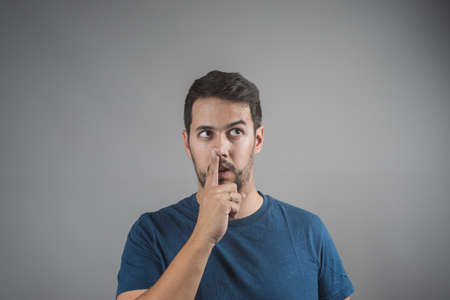 young man picking his nose with his fingerの写真素材